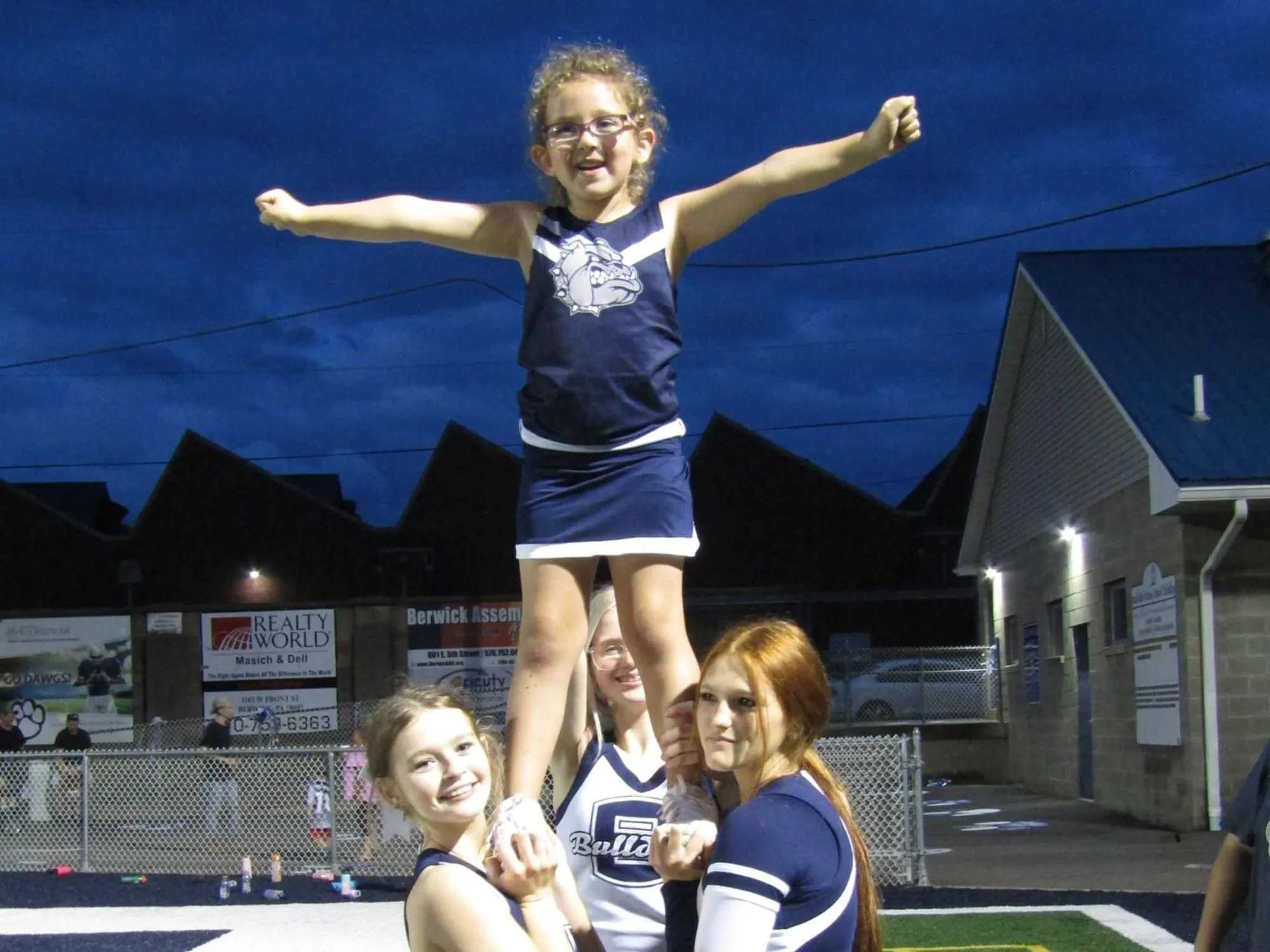 Youth Cheerleaders in pyramid formatino
